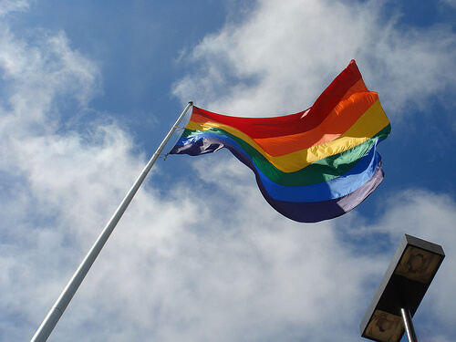 A gay rainbow flag on a flagpole