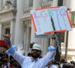 A supporter of LGBTQ rights holding a sign at a rally.