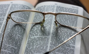 Open Bible with glasses on top