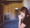 High School Student Praying in a Corridor.